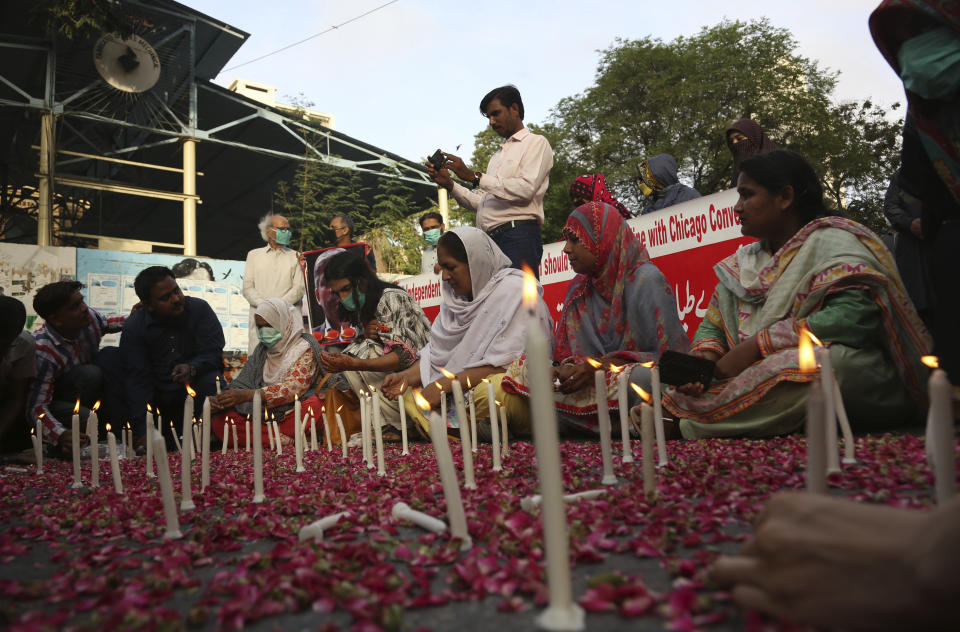 People attend candlelight vigil for victims of the crash of a state-run Pakistan International Airlines plane, in Karachi, Pakistan, Thursday , May 28, 2020. (AP Photo/Fareed Khan)