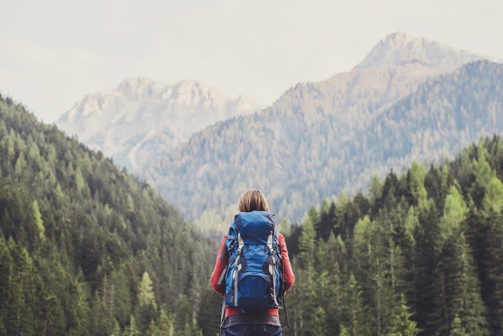 Young girl traveler on a walking route.