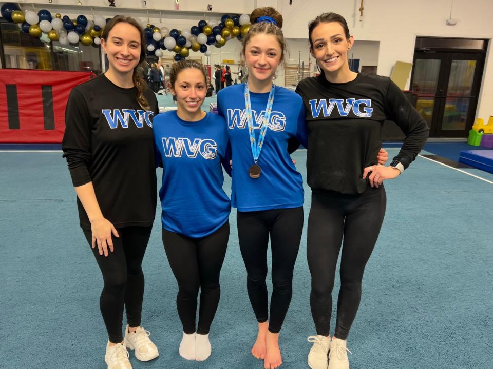 Wappingers gymnasts Abigale Verrechia and Emma Dwyer, center, pose while flanked by coaches Danielle Bethel and Sarah Grunbok after earning berths to the state tournament.