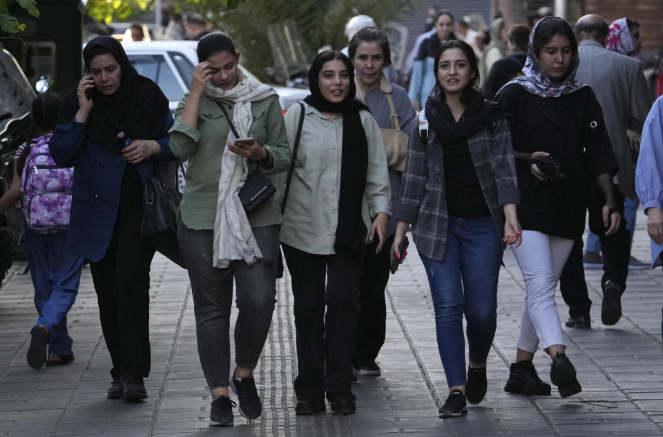 Iranian women, some without wearing their mandatory Islamic headscarves, walk in downtown Tehran, Iran, Saturday, Sept. 9, 2023. Iranians are marking the first anniversary of nationwide protests over the country's mandatory headscarf law that erupted after the death of a young woman detained by morality police. (AP Photo/Vahid Salemi)