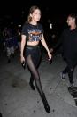 <p>In a cropped rocker Rolling Stones tee, sheer-paneled black pants and leather booties for a girls' night out with Kendall Jenner in Los Angeles</p>