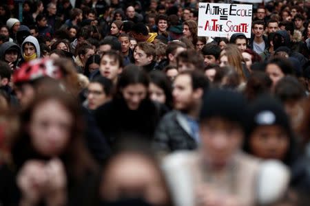 Youths and high school students attend a demonstration to protest against the French government's reform plan, in Paris, France, December 7, 2018. The slogan reads "Another school = another society". REUTERS/Benoit Tessier