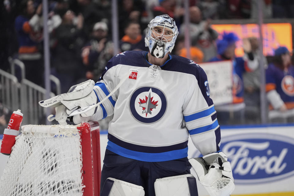 Winnipeg Jets goaltender Connor Hellebuyck (37) reacts after New York Islanders' Mathew Barzal scored a goal during the second period of an NHL hockey game Saturday, March 23, 2024, in Elmont, N.Y. (AP Photo/Frank Franklin II)