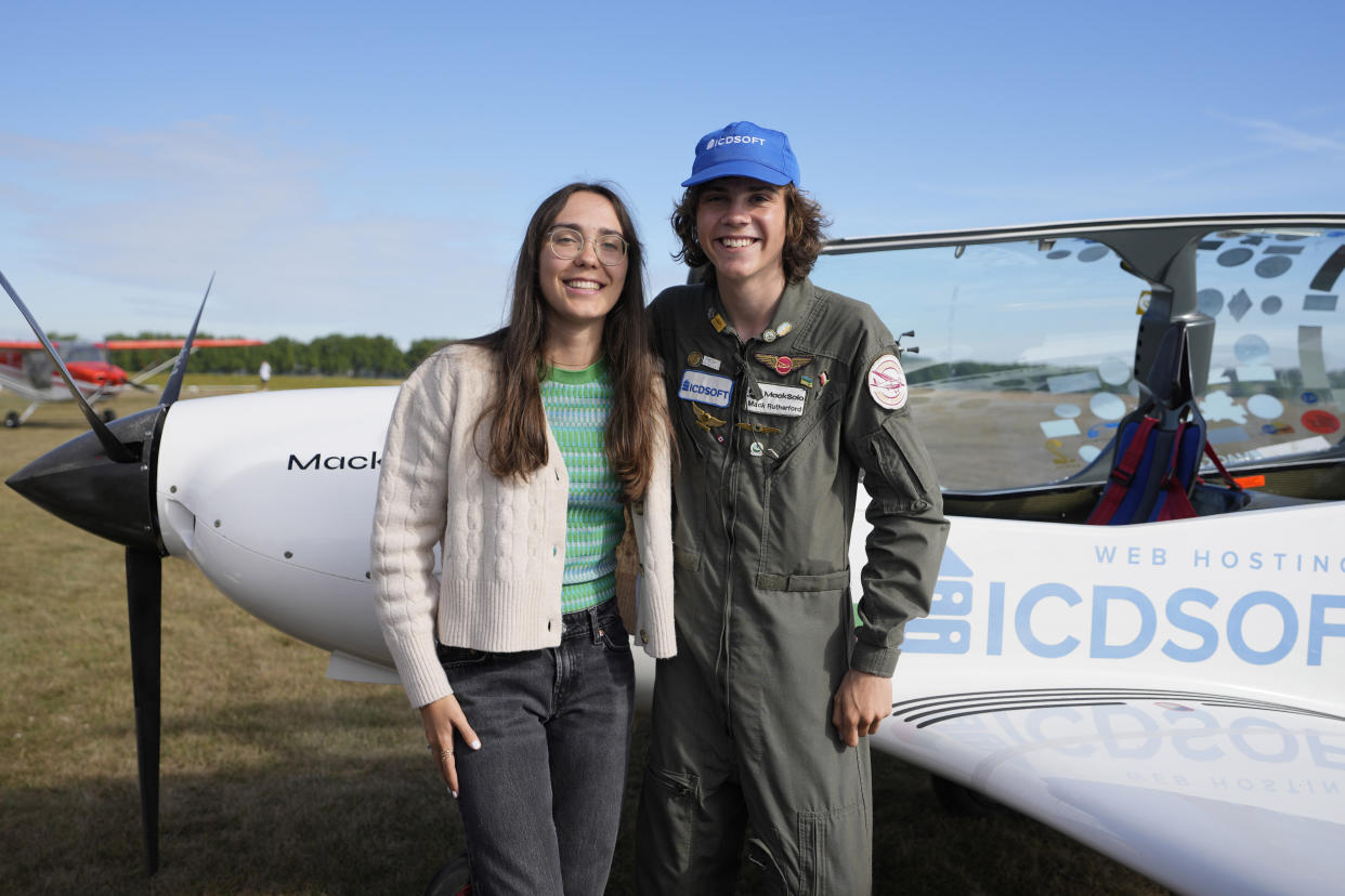 Seventeen year old Anglo-Belgian pilot, Mack Rutherford, right, poses with his sister Zara Rutherford after landing at the Buzet airfield in Pont-A-Celles, Belgium, Tuesday, Aug. 23, 2022. Rutherford landed in Belgium before flying on to Slovakia and Sofia, Bulgaria, for the final leg of his Guinness World Record attempt to be the youngest person to the fly around the world solo in a small plane. Zara Rutherford set a world record as the youngest woman to fly solo around the world at nineteen years old. (AP Photo/Virginia Mayo)