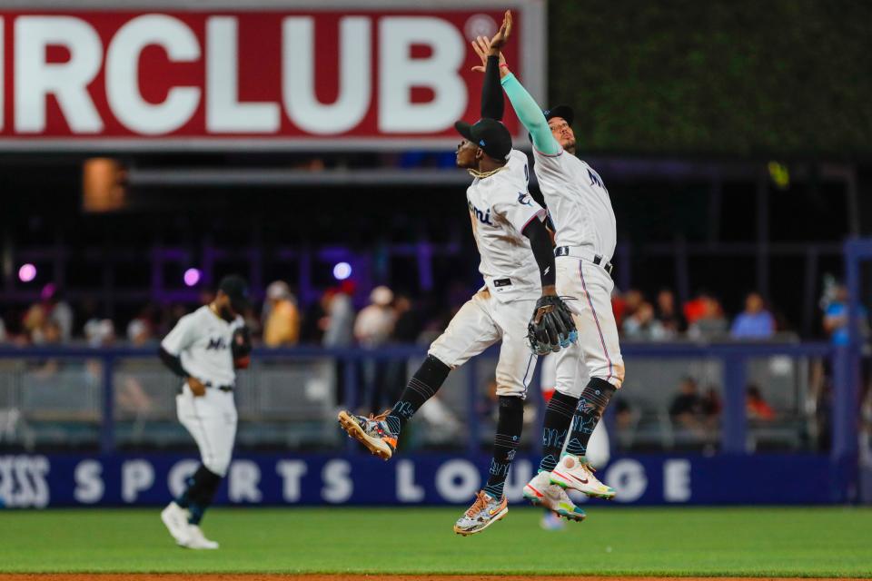 Miami Marlins second baseman Jazz Chisholm Jr., left, and shortstop Miguel Rojas celebrate Thursday after beating the Washington Nationals at loanDepot park.