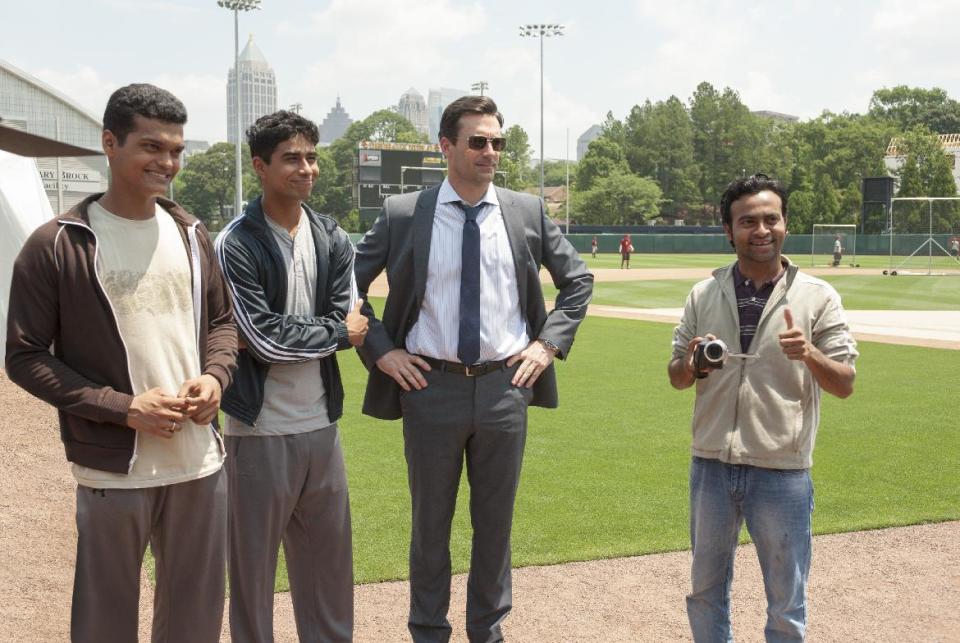 This image released by Disney shows, from left, Madhur Mittal, Suraj Sharma, Jon Hamm and Pitobash in a scene from "Million Dollar Arm." (AP Photo/Disney, Ron Phillips)