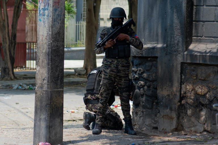 Policías haitianos hacen guardia en una esquina en medio de la violencia de pandillas en Puerto Príncipe, el 8 de abril de 2024 (Clarens SIFFROY)