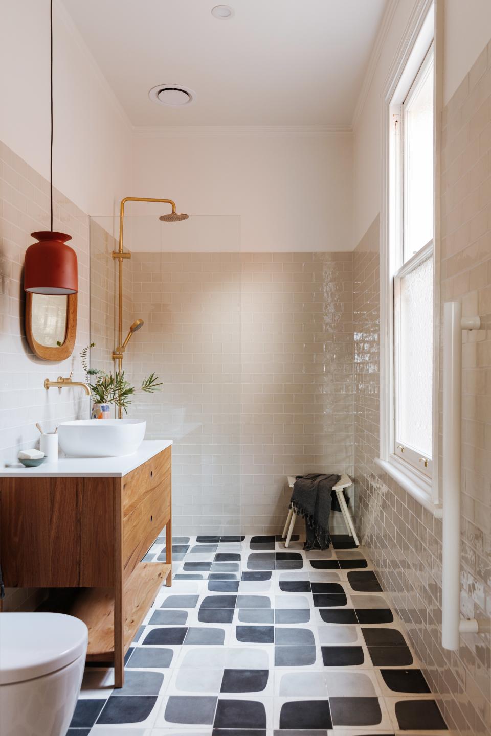 Although Amy and Ben wanted anything but a “beige” renovation, Kate says, a neutral color was used for the master bath’s wall tiling so that the floor could be highlighted. Popham Design custom-made the blue tiles, which the owners wanted in a bold geometric pattern.