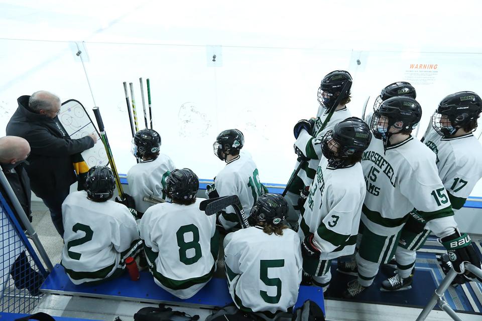 Marshfield head coach Dan Connolly talks strategy with his team before their game against Scituate at Hobomock Arena on Saturday, Jan. 2, 2021. 