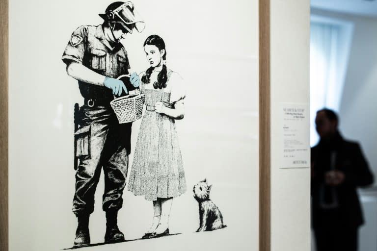 The dark wit of Banksy's art -- such as this work that went up for auction at the French auction house Artcurial in October -- has earned him an international following