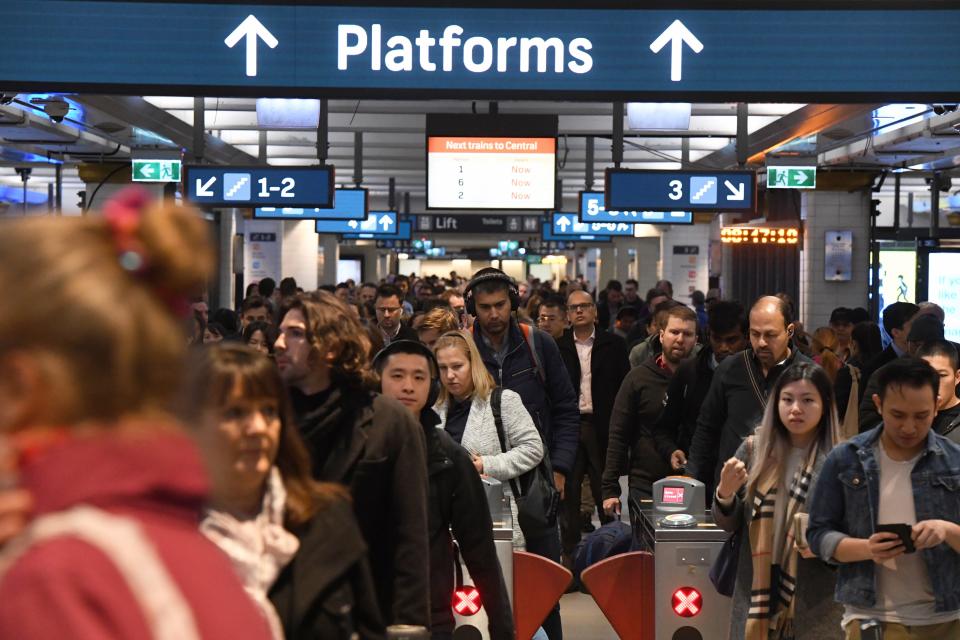 Commuters are seen at Town Hall train station in Sydney, Friday, August 23, 2019. A train breakdown at Town Hall station is causing delays on the network. AAP/Peter Rae