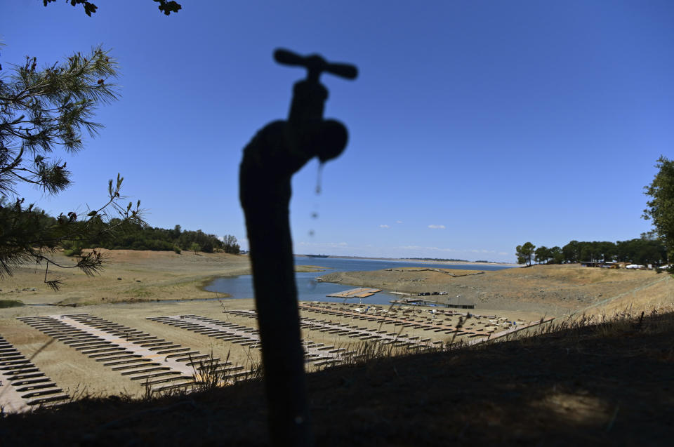 Water drips from a faucet near boat docks sitting on dry land at the Browns Ravine Cove area of drought-stricken Folsom Lake, currently at 37% of its normal capacity, in Folsom, Calif., Saturday, May 22, 2021. California Gov. Gavin Newsom declared a drought emergency for most of the state. (AP Photo/Josh Edelson)