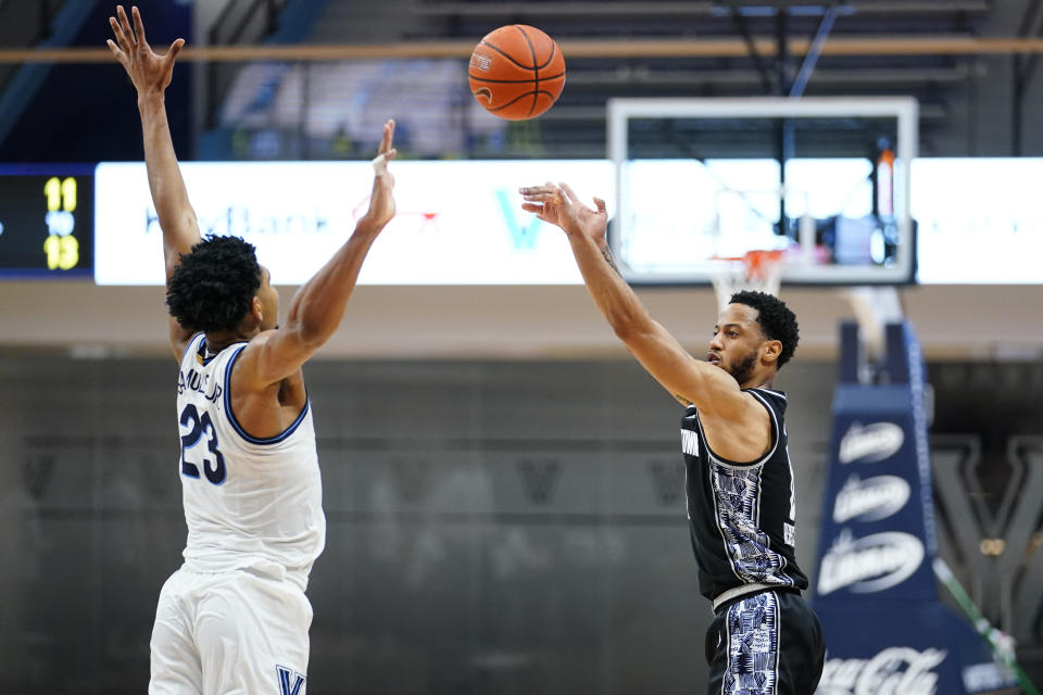 Georgetown's Jahvon Blair, right, goes up for a shot against Villanova's Jermaine Samuels during the second half of an NCAA college basketball game, Sunday, Feb. 7, 2021, in Villanova, Pa. (AP Photo/Matt Slocum)