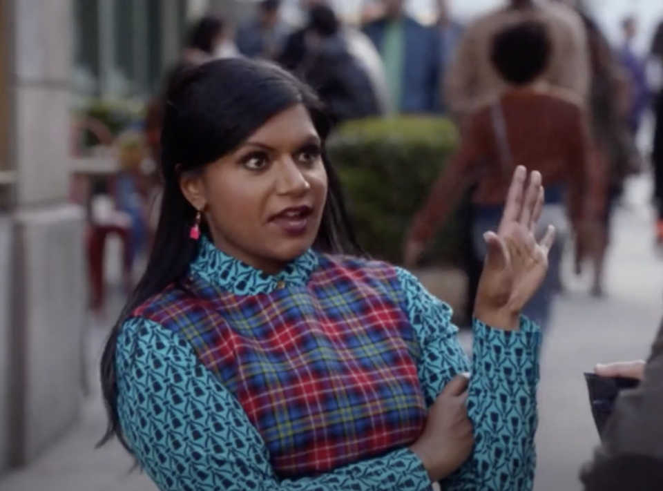 Aggravated Mindy Kaling sticking her hand out in defiance