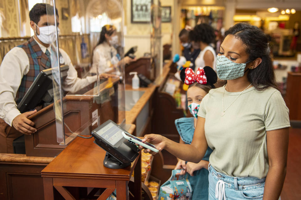 Guests at Walt Disney World Resort theme parks in Lake Buena Vista, Fla., are encouraged to use cashless payment options whenever possible when making purchases as the parks begin their phased reopening July 11, 2020. (Disney/David Roark)