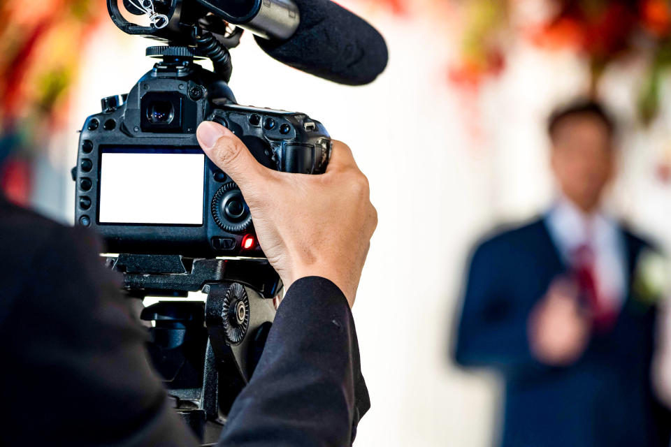 A videographer tapes a wedding