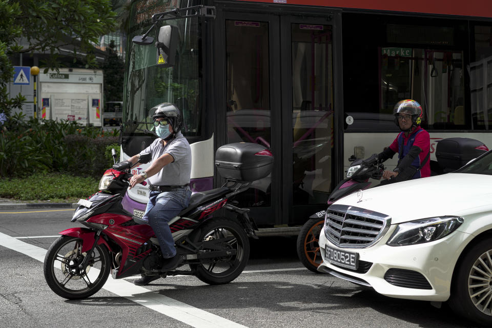 SINGAPORE, SINGAPORE - FEBRUARY 28: A motorist wearing a mask waits at the traffic at the Central Business District on February 28, 2020 in Singapore. The coronavirus, originating in Wuhan, China has spread to over 80,000 people globally, more than 50 countries have now been infected.  (Photo by Ore Huiying/Getty Images)