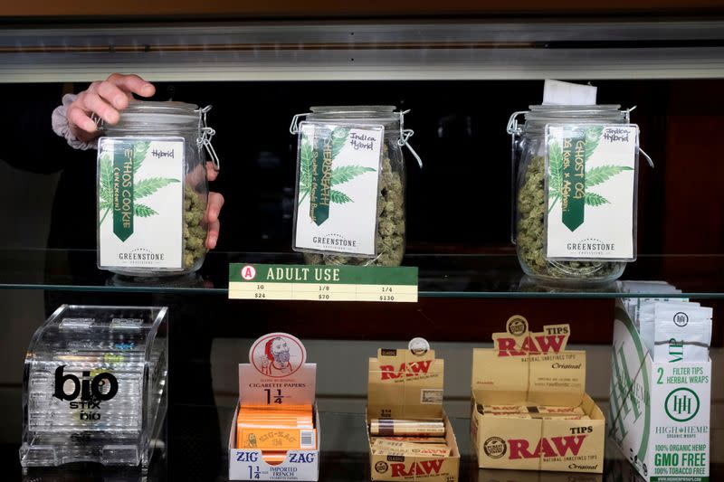 FILE PHOTO: An employee holds a jar of marijuana on sale at the Greenstone Provisions in Ann Arbor