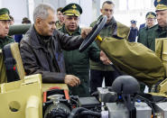 In this photo released by the Russian Defense Ministry Press Service on Wednesday, April 17, 2024, Russian Defense Minister Sergei Shoigu, foreground, visits an exhibition of the new scientific and technical developments in the logistics system of the Russian Armed Forces at the Patriot Convention and Exhibition Center outside Moscow, Russia. Shoigu checked the implementation of instructions on the development of robotic systems, advanced weapons systems, as well as support for military personnel. (Russian Defense Ministry Press Service via AP)