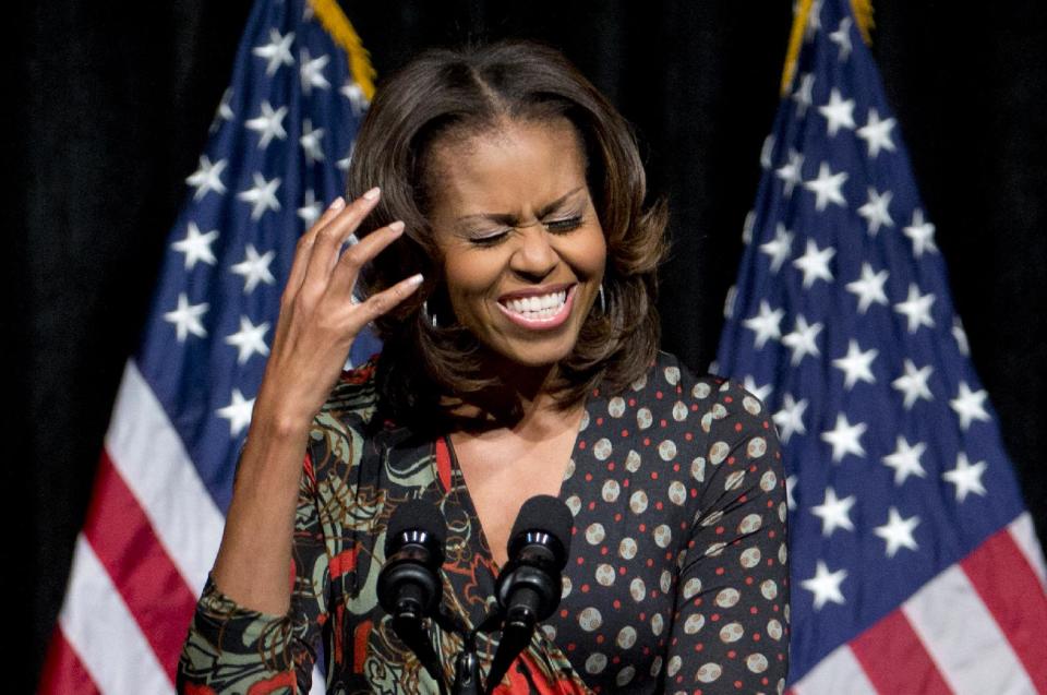 First lady Michelle Obama gestures as he speaks to students about committing to education to create a better future for themselves and their country, Tuesday, Nov. 12, 2013, at Bell Multicultural High School in Washington. Edging into a broader policy role, Michelle Obama is joining President Barack Obama's efforts to get the United States on track to have the highest percentage of college graduates by 2020. (AP Photo/Carolyn Kaster)