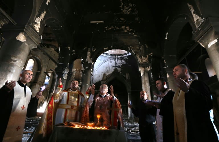 Archbishop Yohanna Petros Mouche (C) of Mosul leads a mass at the Church of the Immaculate Conception on October 30, 2016 in the town of Qaraqosh, 30 kms east of Mosul, after Iraqi forces recaptured it from the Islamic State