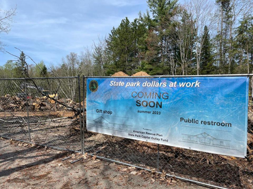 A sign announces the construction site and future upgrades at Tahquamenon Falls State Park.