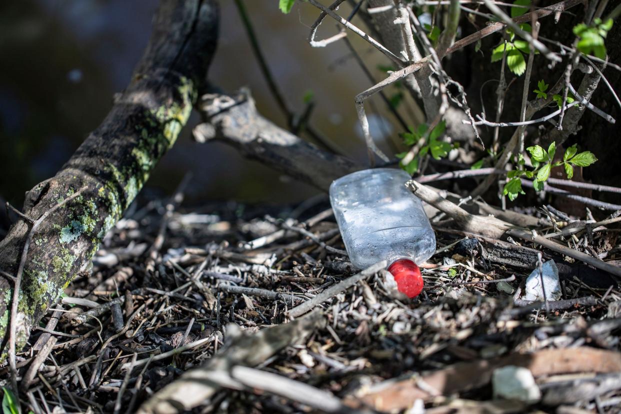 Trash litters the debris runoff from the lower Rouge River near Ford Field park in Dearborn, Mich. on Friday, April 19, 2024.