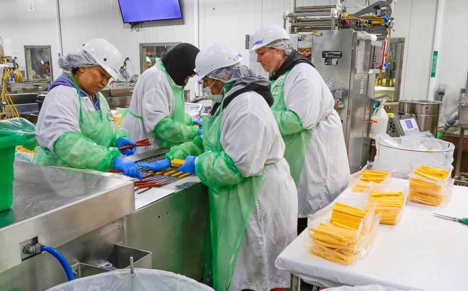 Workers at Old Wisconsin Sausage assemble sausage and cheese packets, Wednesday, July 27, 2022, in Sheboygan, Wis.