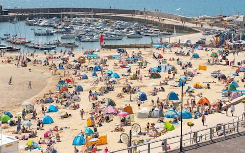 Holidaymakers and day trippers pack the beach at Lyme Regis in Dorset - Credit: Celia McMahon/Alamy Live News