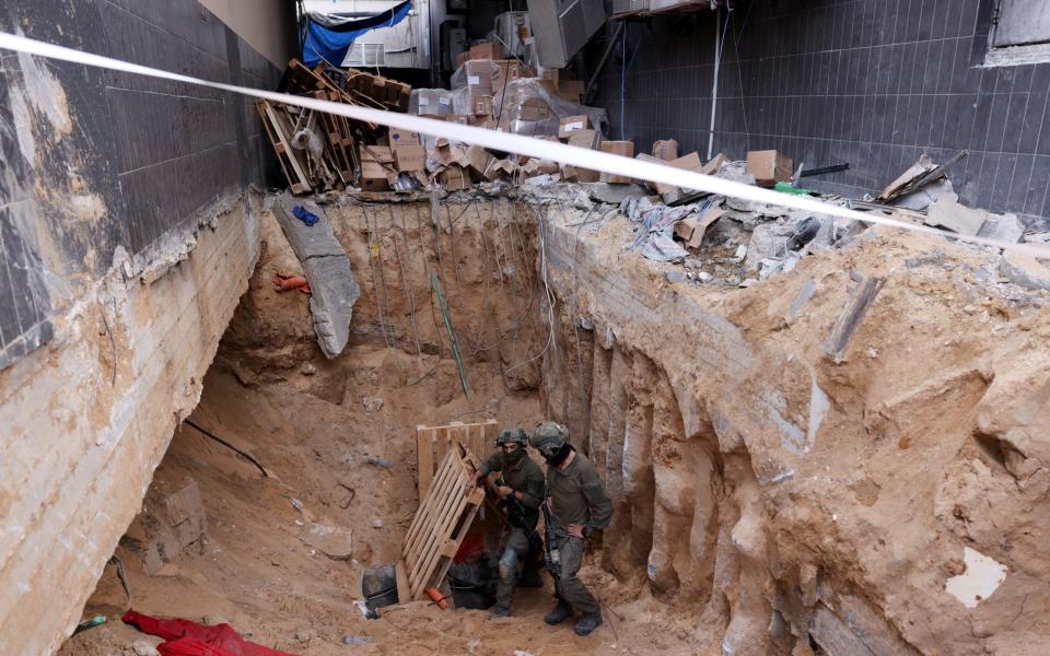 Israeli soldiers operate at the opening to a tunnel at Al Shifa Hospital compound in Gaza City