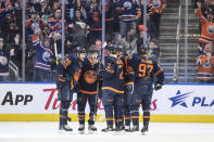 Edmonton Oilers players celebrate after a goal against the Buffalo Sabres during first-period NHL hockey game action in Edmonton, Alberta, Thursday March 21, 2024. (Jason Franson/The Canadian Press via AP)