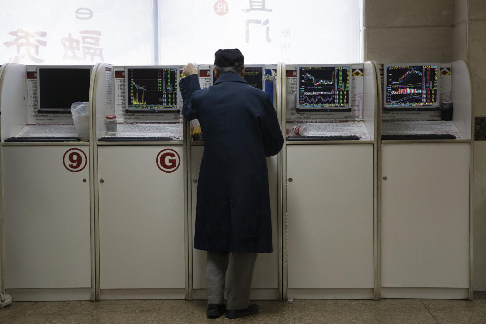 In this Monday, Nov. 11, 2019, photo, an investor monitors stock prices at a brokerage in Beijing. Shares were mixed in Asia on Tuesday, Nov. 12, as investors awaited cues on trade talks between China and the U.S. (AP Photo/Ng Han Guan)