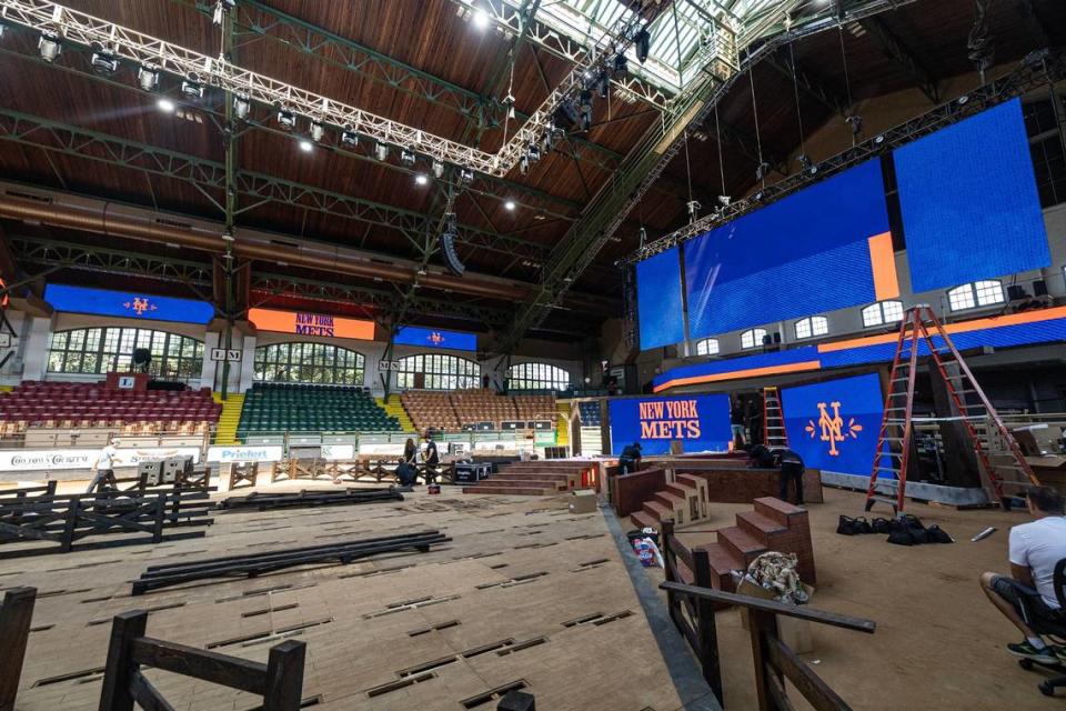 Workers begin to work on transforming the inside of the Cowtown Coliseum for the 2024 MLB Draft in the Fort Worth Stockyards on Thursday.