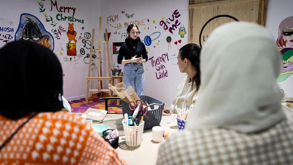 Shurrab talks to other Palestinians who fled the war about how to heal through journaling at her workshop in Cairo. (NBC News)