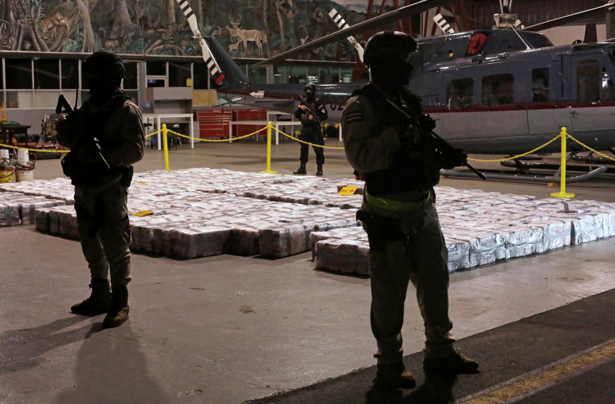 Costa Rican police officers are seen on Saturday February 15, 2020, in front of packages containing cocaine seized during an operation in the Caribbean: Reuters