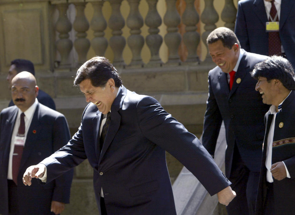 FILE - In this Dec. 9, 2006 file photo, Peru's President Alan García laughs out accompanied by Venezuelan President Hugo Chavez and of Bolivian President Evo Morales, as they break apart after gathering for a group photo at the Community of South American Nations summit, in Cochabamba, Bolivia. Current Peruvian President Martinez Vizcarra said Garcia, the 69-year-old former head of state died Wednesday, April 17, 2019, after undergoing emergency surgery in Lima. Garcia shot himself in the head early Wednesday as police came to detain him in connection with a corruption probe. (AP Photo/Dado Galdieri, File)