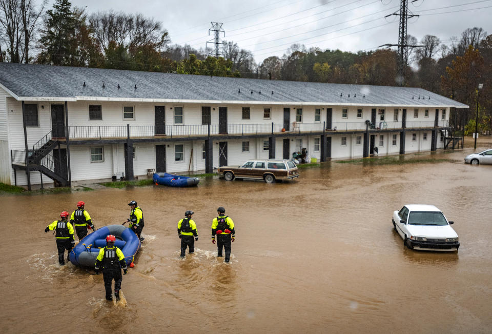 Firefighters with the Winston-Salem Fire Department arrive at Creekwood Apartments to assist with evacuations due to flooding on Thursday, Nov. 12, 2020 in Winston-Salem, N.C. (Andrew Dye/The Winston-Salem Journal via AP)