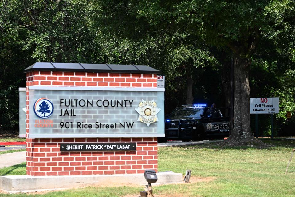 Fulton County sheriffs stand guard outside the Fulton County Jail