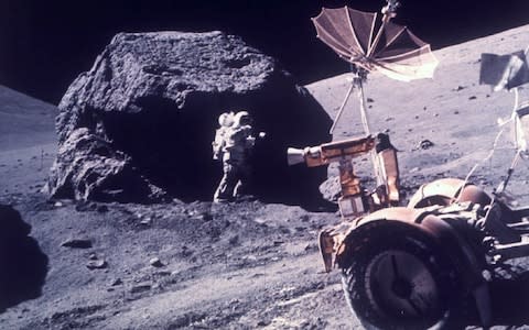 Harrison Jack Schmitt taking samples from a boulder which never saw sunlight - Credit: Nasa