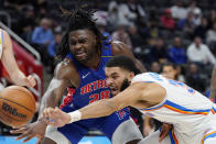 Oklahoma City Thunder forward Kenrich Williams (34) reaches for the rebound next to Detroit Pistons center Isaiah Stewart (28) during the second half of an NBA basketball game, Monday, Dec. 6, 2021, in Detroit. (AP Photo/Carlos Osorio)