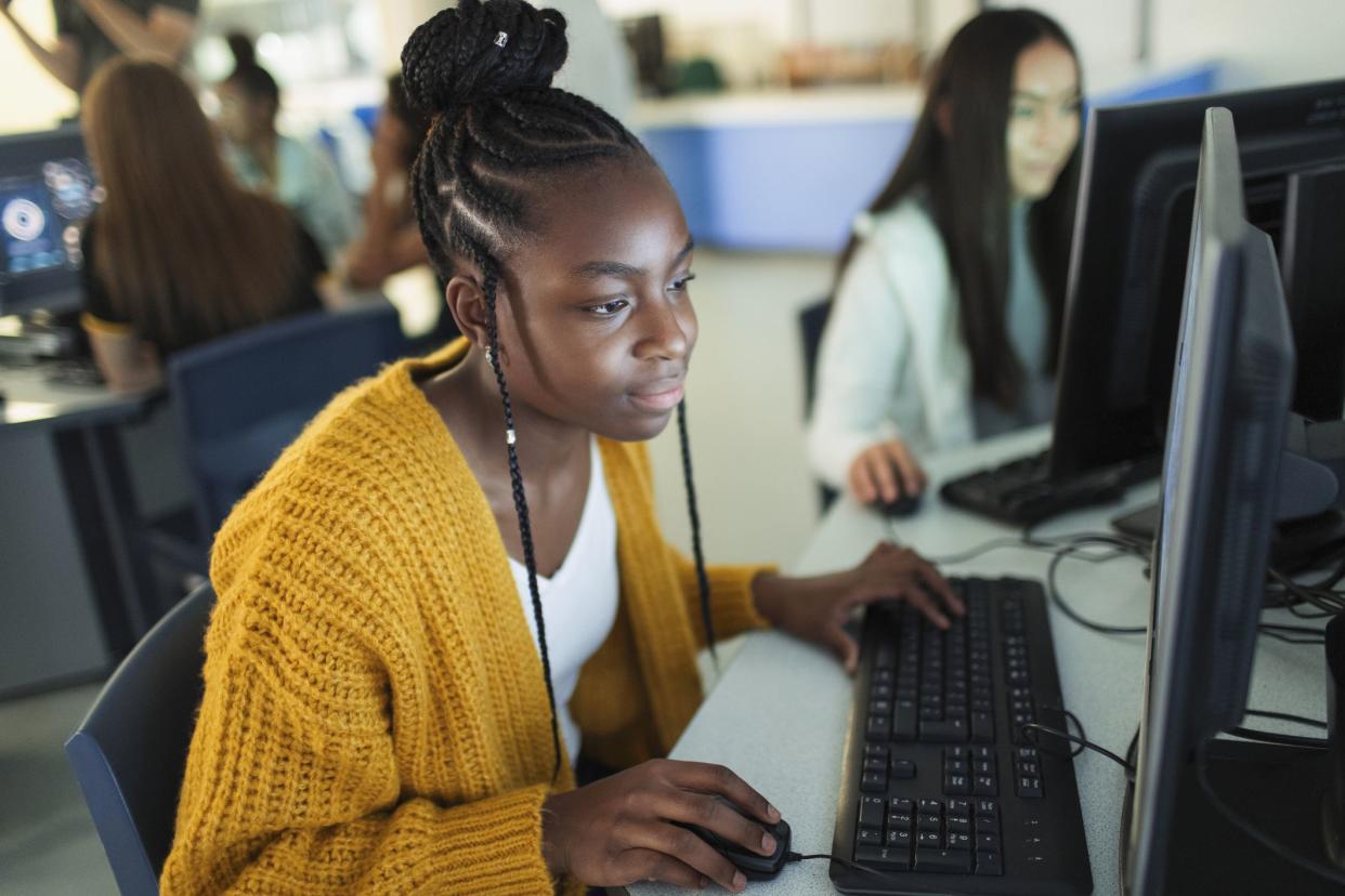 students working on desktop computers in school computer lab