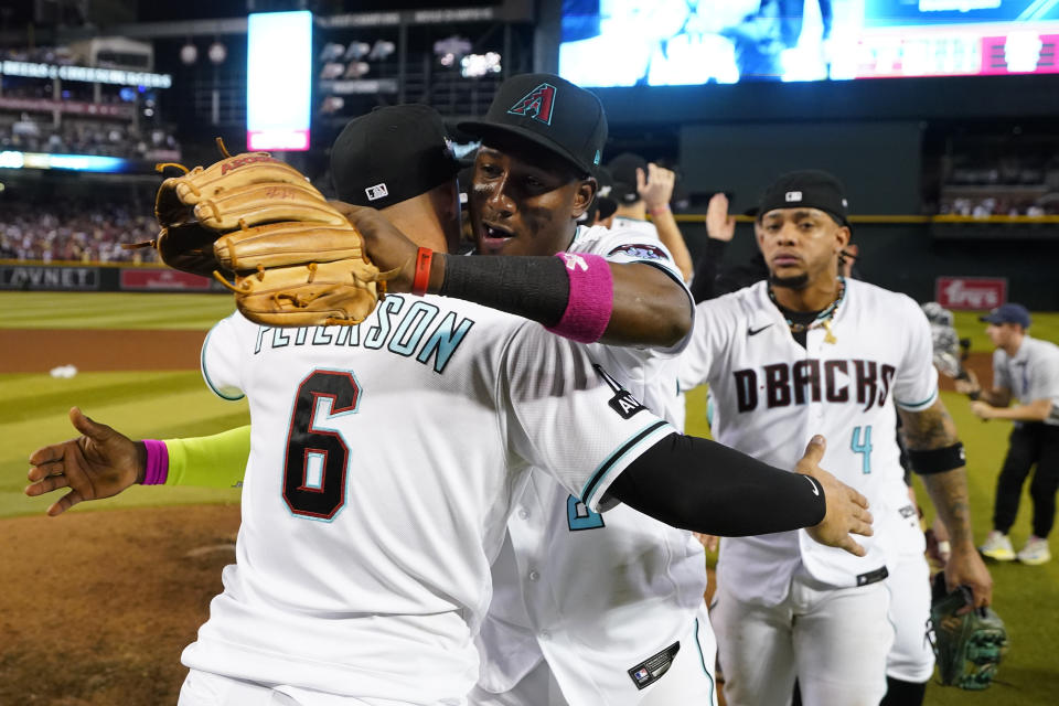 Arizona Diamondbacks third baseman Jace Peterson (6) celebrates with teammate Geraldo Perdomo after the Diamondbacks defeated the Los Angeles Dodgers 4-2 in Game 3 to win a baseball NL Division Series, Wednesday, Oct. 11, 2023, in Phoenix. (AP Photo/Ross D. Franklin)