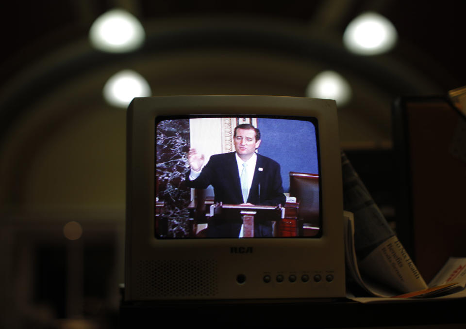 Image: Seen on a television screen in the Senate Press Gallery, Sen. Ted Cruz, R-Texas, speaks during the seventh hour of his filibuster on the Senate floor (Charles Dharapak / AP file)