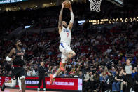 Los Angeles Clippers guard Amir Coffey goes to the basket in front of Portland Trail Blazers center Deandre Ayton during the second half of an NBA basketball game in Portland, Ore., Wednesday, March 20, 2024. (AP Photo/Craig Mitchelldyer)