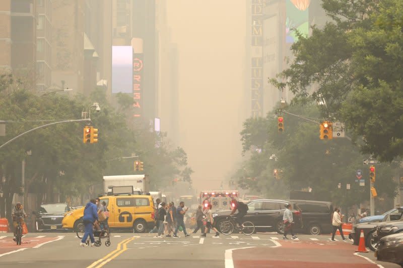 Pedestrians cross 42nd Street in New York City as it is enveloped in smoke from wildfires in Canada on June 7. Millions of people in the eastern United States faced continued unhealthy air quality conditions as smoke from wildfires in eastern Canada wafted over much of the country. File Photo by John Angelillo/UPI