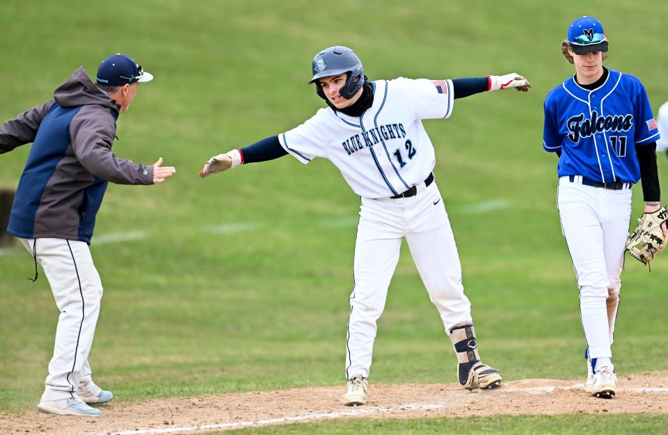 Brayden Ramsey of Sandwich celebrates with his coach Bryan Morry after hitting a triple on Friday, April 7, 2023.