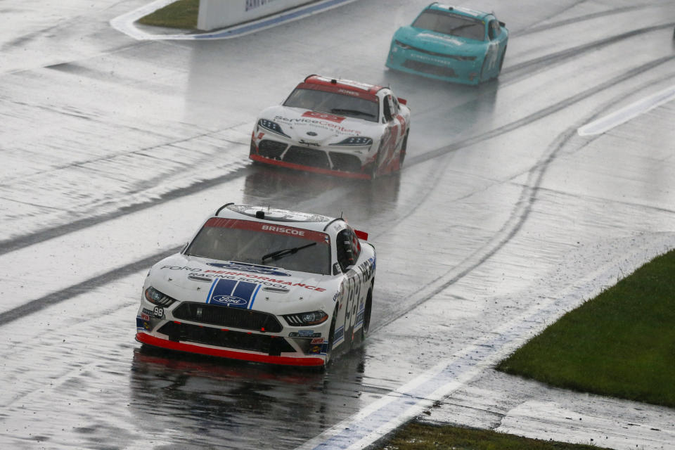 (L-R) Chase Briscoe, Brandon Jones and Gray Gauilding compete in the rain during a NASCAR Xfinity Series auto race at Charlotte Motor Speedway in Concord, N.C., Saturday, Oct. 10, 2020. (AP Photo/Nell Redmond)