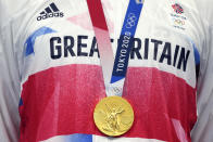 Tom Dean of Britain gold medal hangs as he stands on the podium after winning the men's 200-meter freestyle at the 2020 Summer Olympics, Tuesday, July 27, 2021, in Tokyo, Japan. (AP Photo/Matthias Schrader)