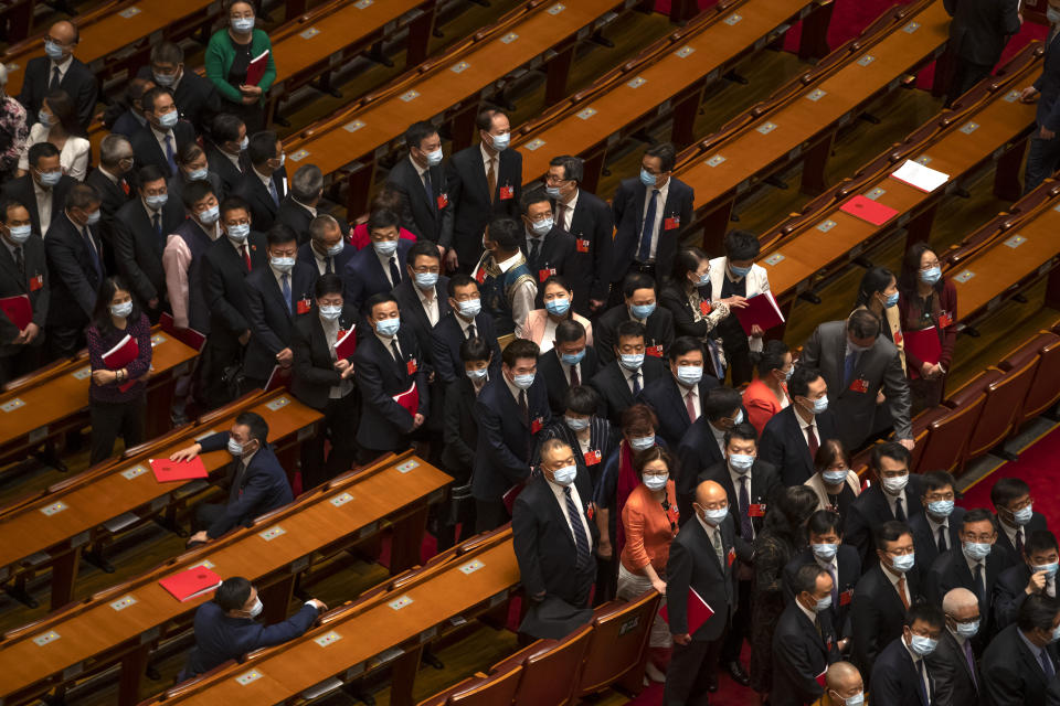 Delegates wait to leave after the closing session of China's National People's Congress (NPC) at the Great Hall of the People in Beijing, Thursday, May 28, 2020. China's ceremonial legislature has endorsed a national security law for Hong Kong that has strained relations with the United States and Britain. (AP Photo/Mark Schiefelbein)