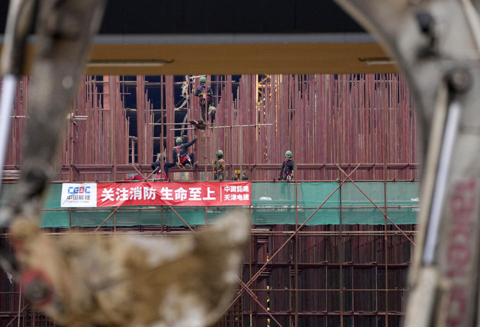 Vietnamese workers at the construction site of the first Chinese car tire factory in Europe near the northern Serbian town of Zrenjanin, 50 kilometers north of Belgrade, Serbia, Thursday, Nov. 18, 2021. Reports have emerged in Serbia of prison-like conditions for some 500 of them at the construction site in north of the country where China's Shandong Linglong Tire Co is building the huge factory. Populist-run Serbia is a key spot for China's expansion and investment policies in Europe and Chinese companies have kept a tight lid on their projects in the country amid reports of disrespect of the Balkan nation's anti-pollution laws and labor regulations. (AP Photo/Darko Vojinovic)